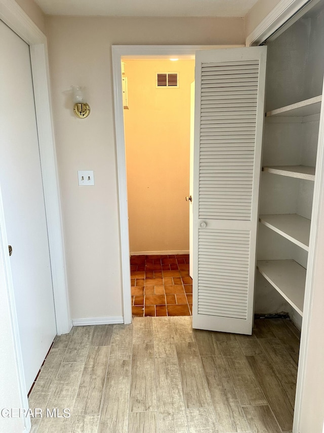 hallway featuring hardwood / wood-style flooring