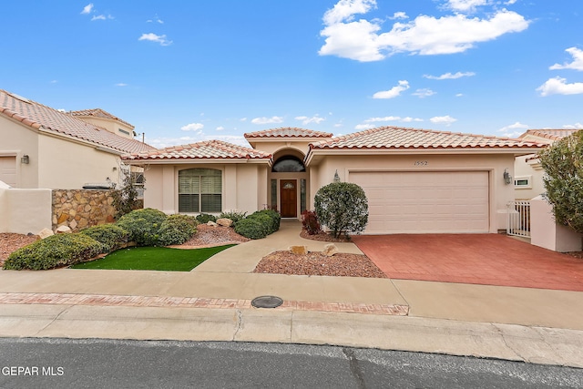 mediterranean / spanish-style house with a garage