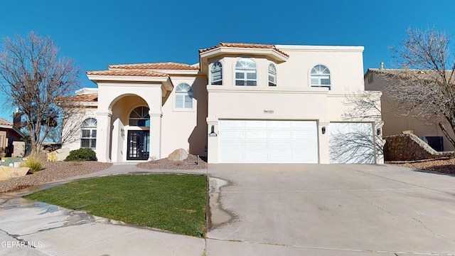 mediterranean / spanish home featuring a garage