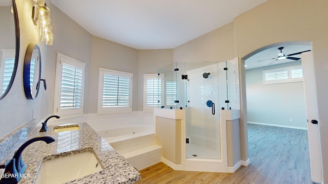 bathroom featuring hardwood / wood-style floors, ceiling fan, and a healthy amount of sunlight