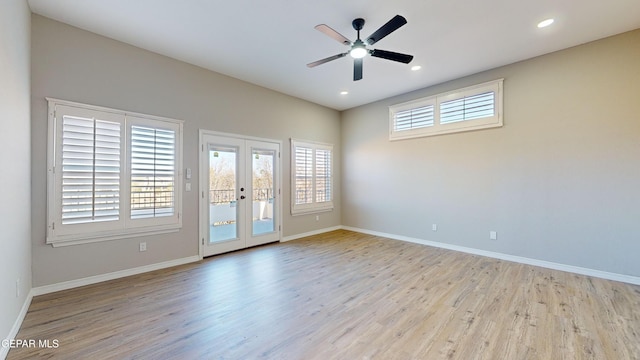 spare room with french doors, light wood-type flooring, and ceiling fan