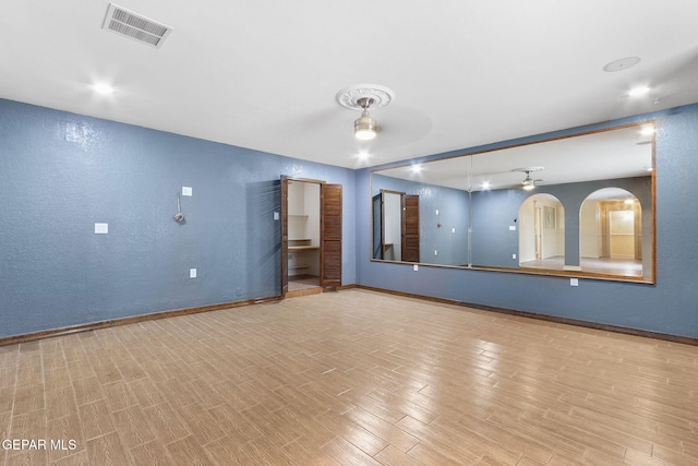 unfurnished living room with ceiling fan