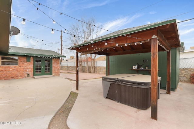 view of patio / terrace with a gazebo, french doors, and a hot tub