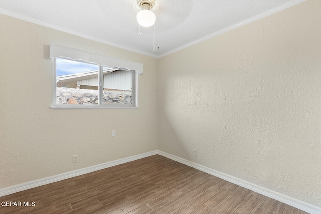 empty room with ceiling fan, hardwood / wood-style floors, and ornamental molding