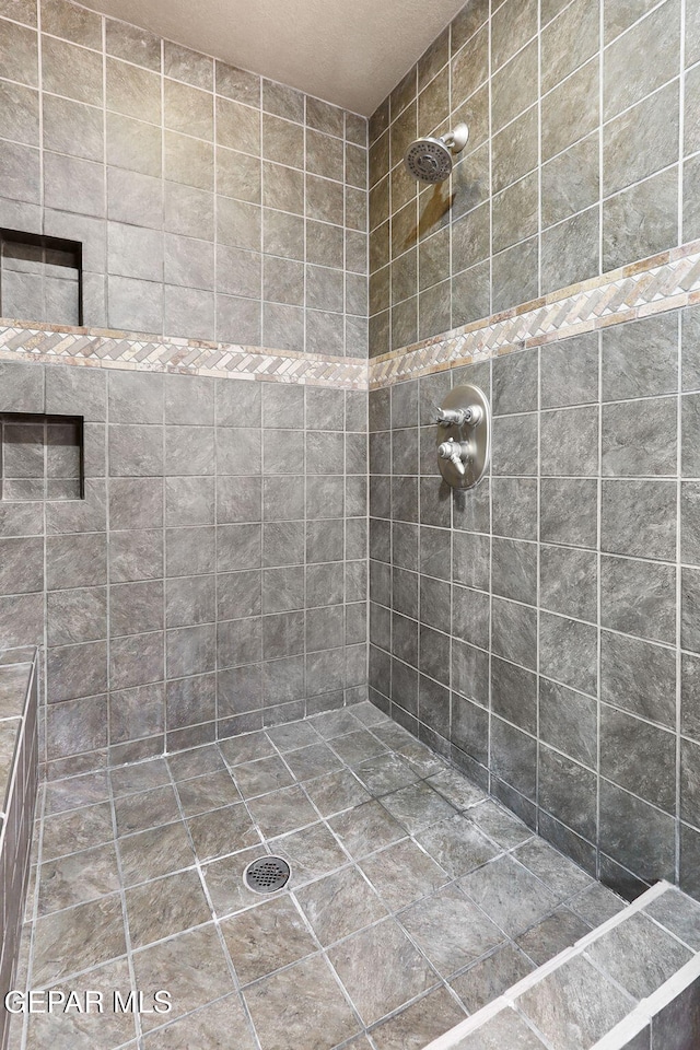 bathroom with a tile shower