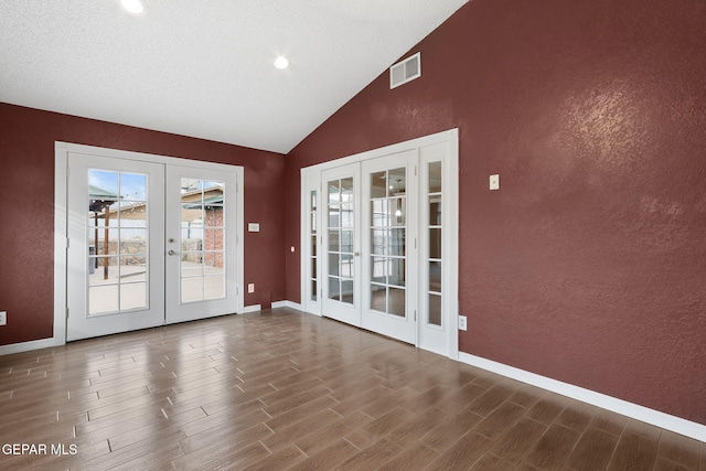 doorway to outside with lofted ceiling, dark wood-type flooring, and french doors