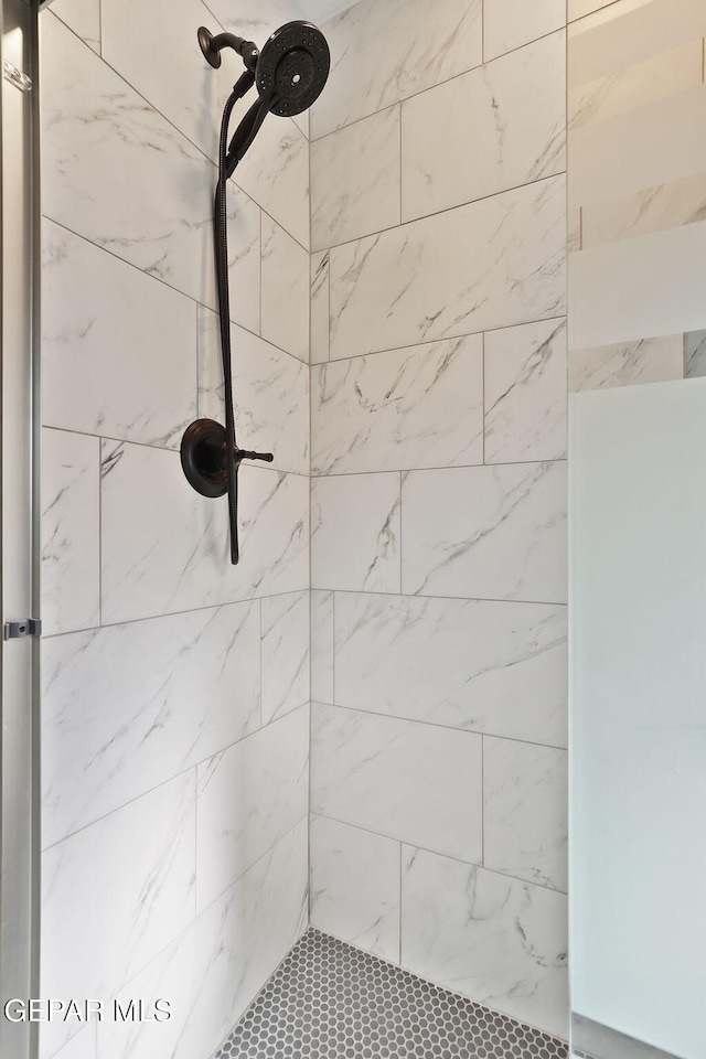 bathroom with tiled shower