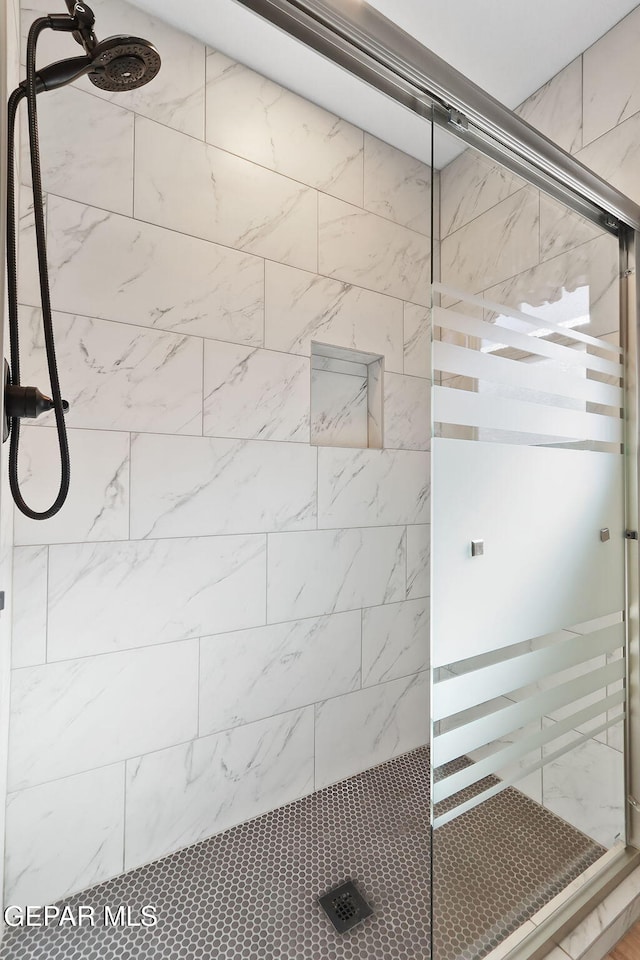 bathroom with a tile shower