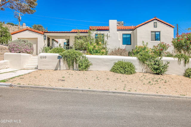 mediterranean / spanish-style home with a garage