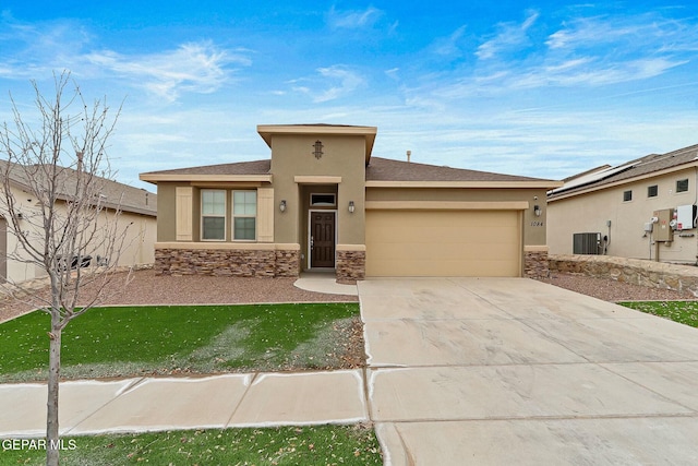 view of front of home with a garage and central AC