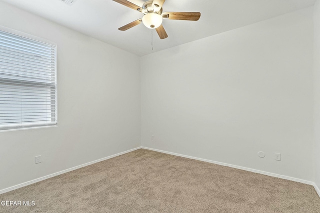 unfurnished room with light colored carpet, plenty of natural light, and ceiling fan