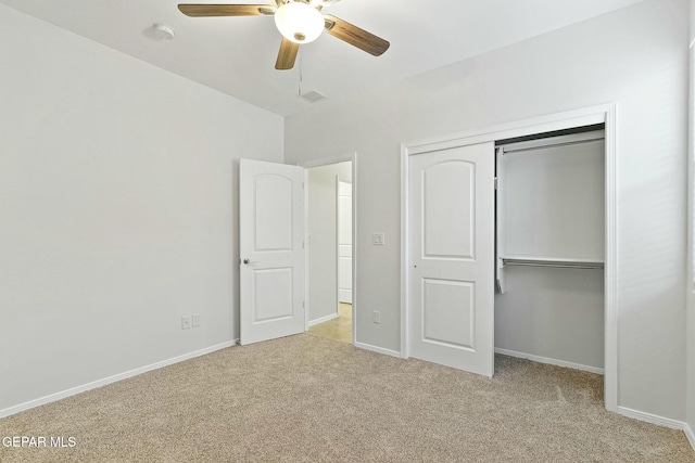 unfurnished bedroom with ceiling fan, a closet, and light colored carpet