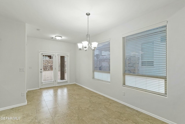 empty room with a notable chandelier