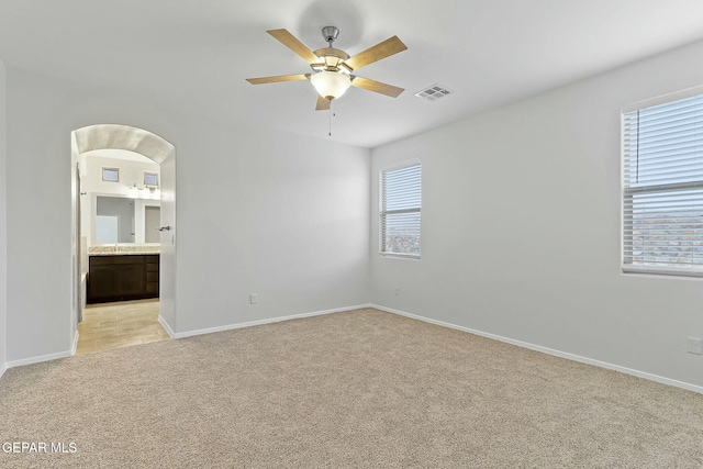 carpeted empty room featuring ceiling fan