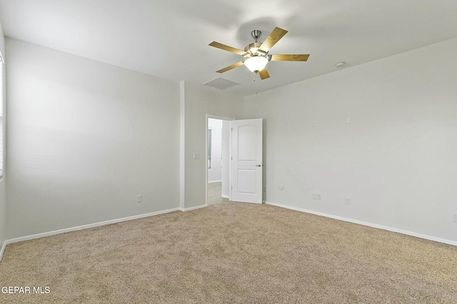 carpeted spare room featuring ceiling fan