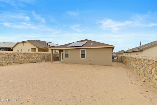 rear view of house with solar panels