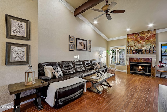 living room with a high end fireplace, vaulted ceiling with beams, ceiling fan, ornamental molding, and hardwood / wood-style flooring