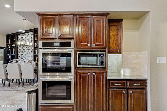 kitchen featuring stainless steel appliances and decorative backsplash