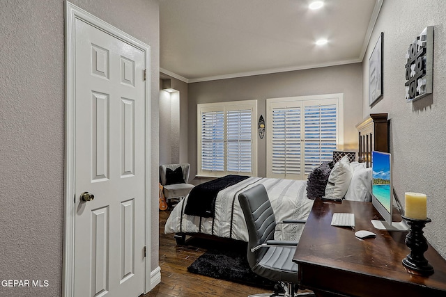 bedroom with dark hardwood / wood-style flooring and ornamental molding