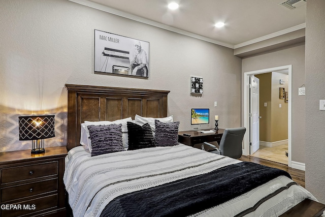 bedroom featuring ornamental molding and light hardwood / wood-style flooring