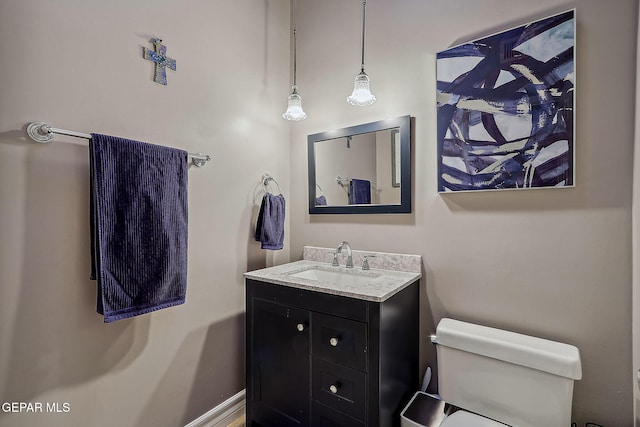 bathroom featuring toilet and vanity