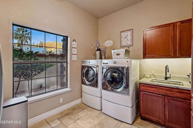 laundry area with cabinets, sink, and washer and clothes dryer