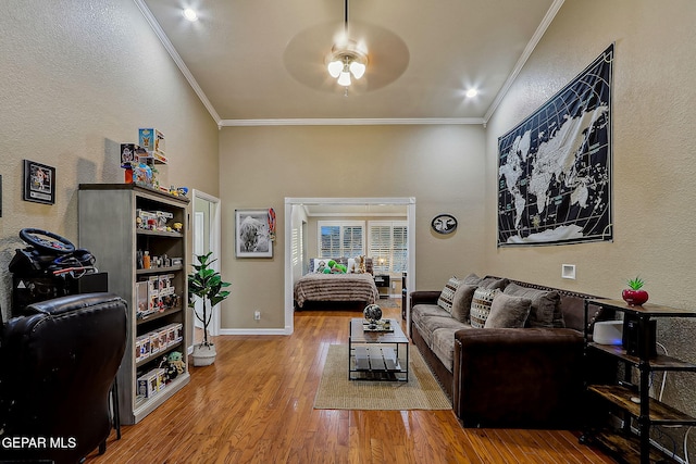 living room featuring ceiling fan, ornamental molding, and hardwood / wood-style floors