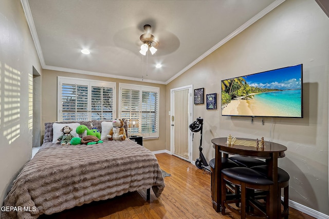 bedroom featuring ceiling fan, hardwood / wood-style floors, crown molding, and lofted ceiling