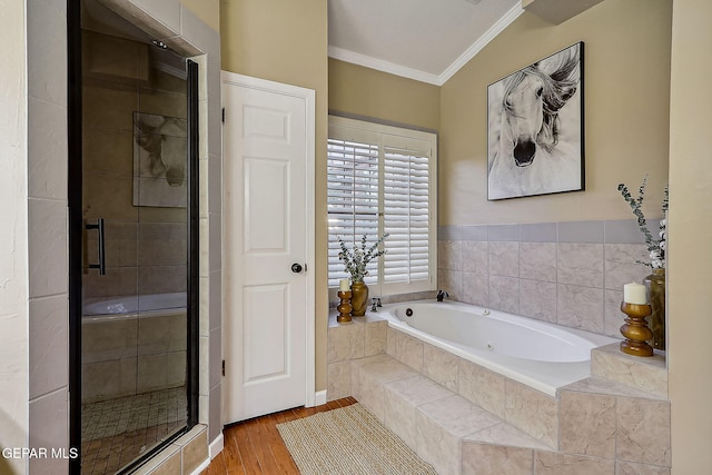 bathroom with hardwood / wood-style floors, crown molding, and plus walk in shower