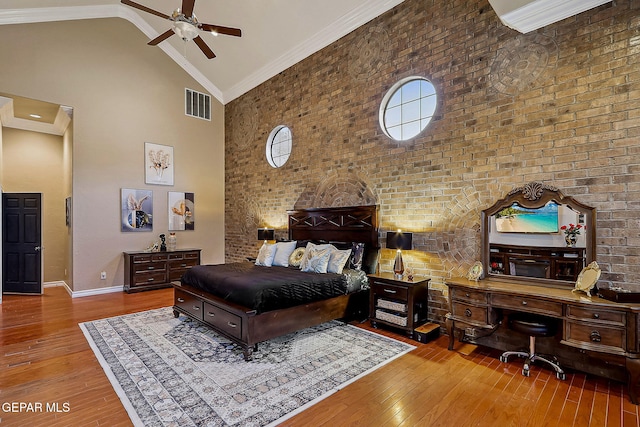 bedroom with high vaulted ceiling, ceiling fan, crown molding, and hardwood / wood-style floors