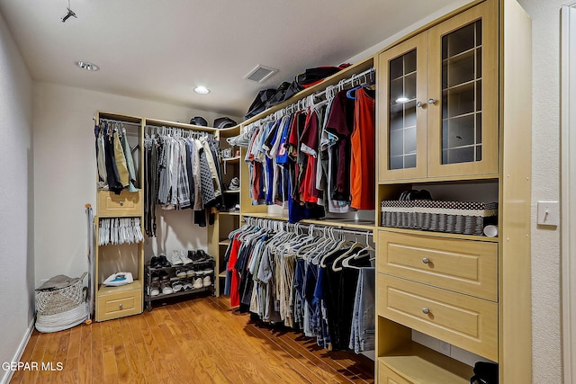 spacious closet with light hardwood / wood-style floors