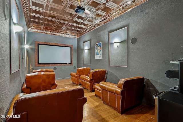 cinema with coffered ceiling and hardwood / wood-style floors