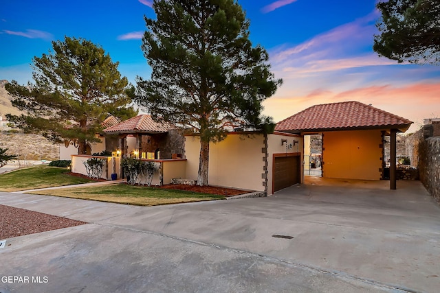 mediterranean / spanish home featuring a lawn, a gazebo, and a garage