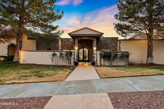 mediterranean / spanish-style home with a yard