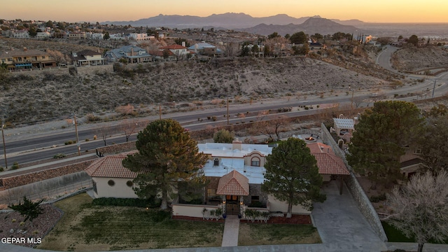 aerial view at dusk featuring a mountain view