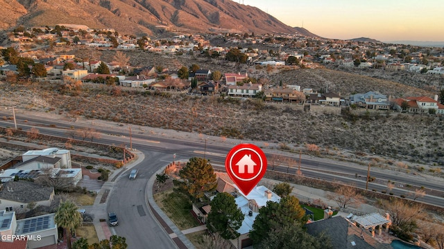 aerial view at dusk featuring a mountain view