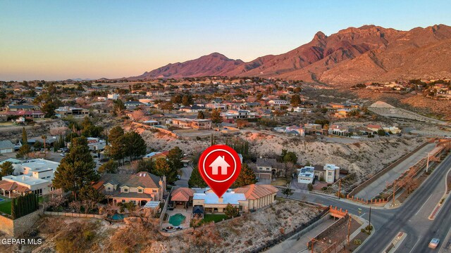 aerial view at dusk featuring a mountain view