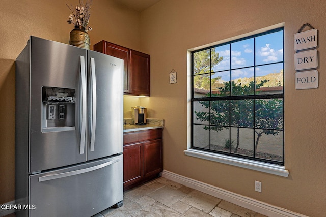 kitchen with stainless steel refrigerator with ice dispenser