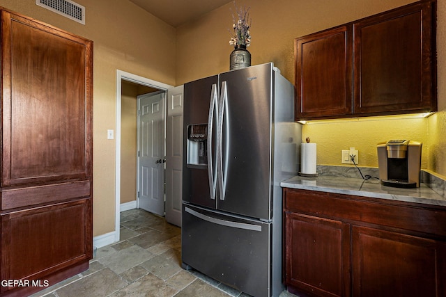 kitchen featuring stainless steel refrigerator with ice dispenser