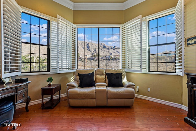 sitting room with crown molding and hardwood / wood-style flooring