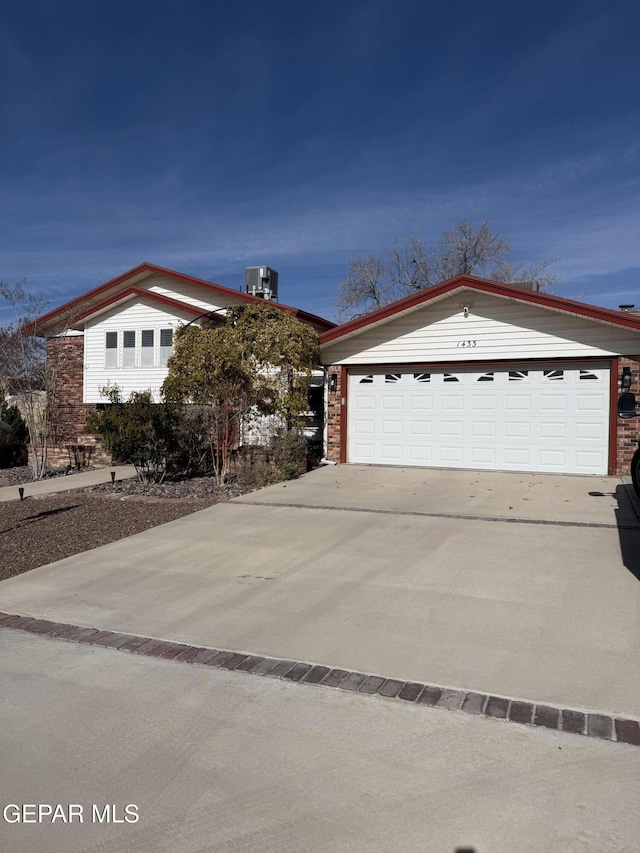 view of front facade featuring central AC and a garage