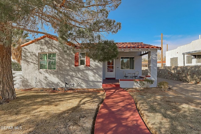 mediterranean / spanish home with a porch