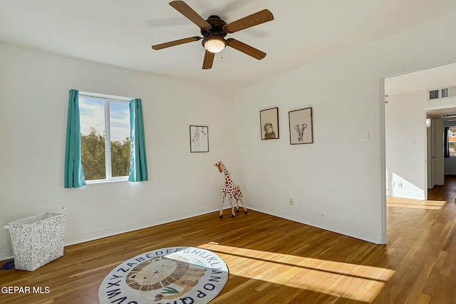 spare room with ceiling fan and hardwood / wood-style flooring