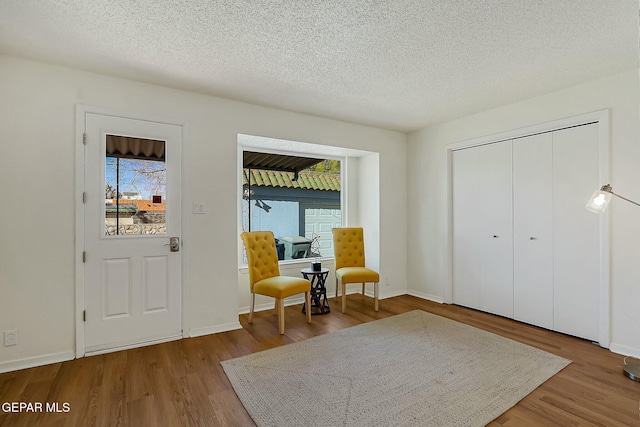 foyer entrance featuring a textured ceiling and hardwood / wood-style flooring