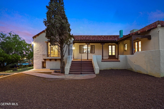 mediterranean / spanish-style home featuring covered porch