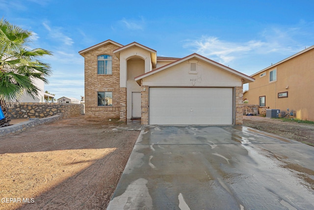 view of front of property with central AC and a garage