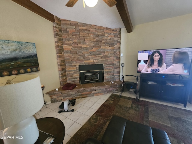 living room featuring vaulted ceiling with beams, ceiling fan, a fireplace, and light tile patterned floors