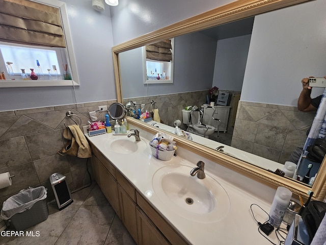 bathroom featuring tile patterned flooring, vanity, and tile walls