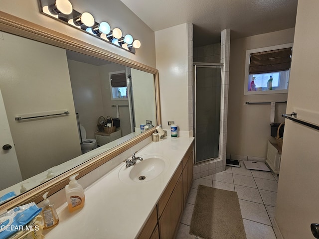 bathroom with walk in shower, tile patterned flooring, a textured ceiling, toilet, and vanity