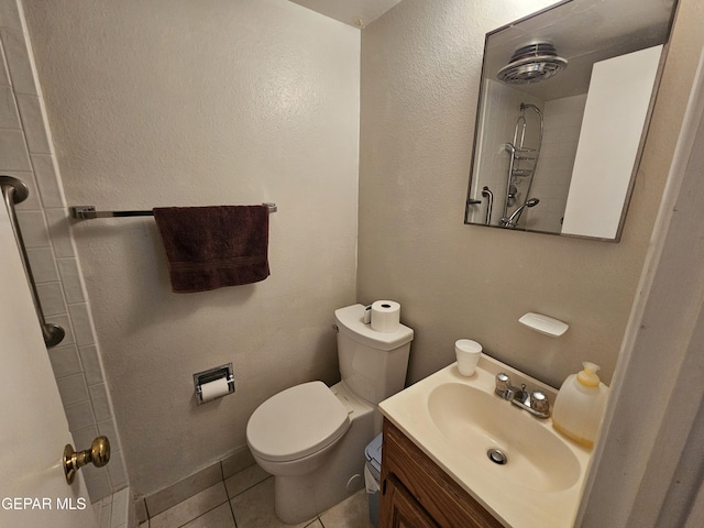 bathroom with tile patterned flooring, a shower, vanity, and toilet